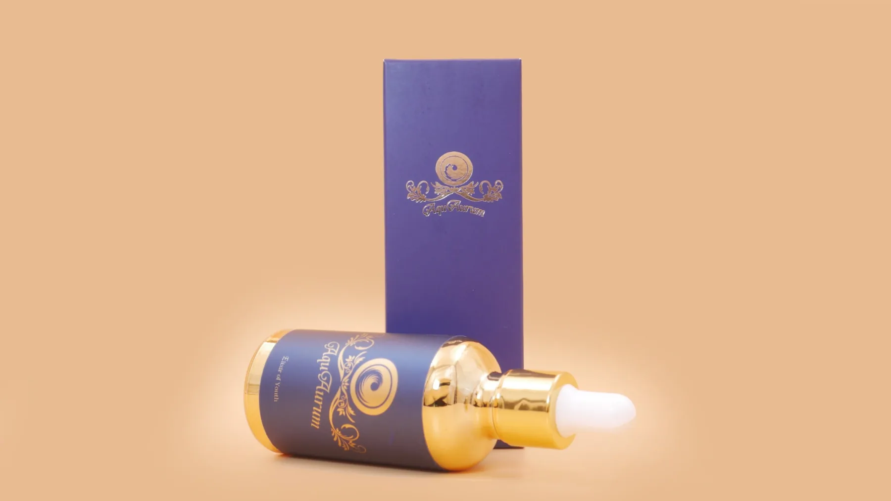 AquAurum gold and blue dropper bottle beside its presentation box