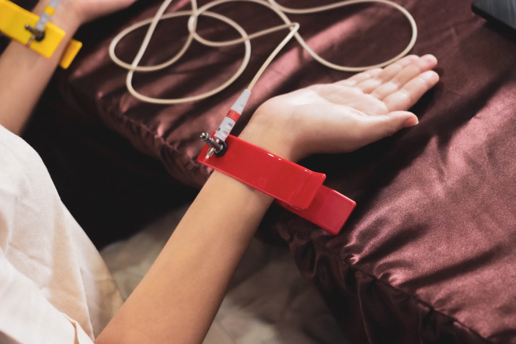 Client resting comfortably while wearing the red Bio Matrix Scan hand electrode