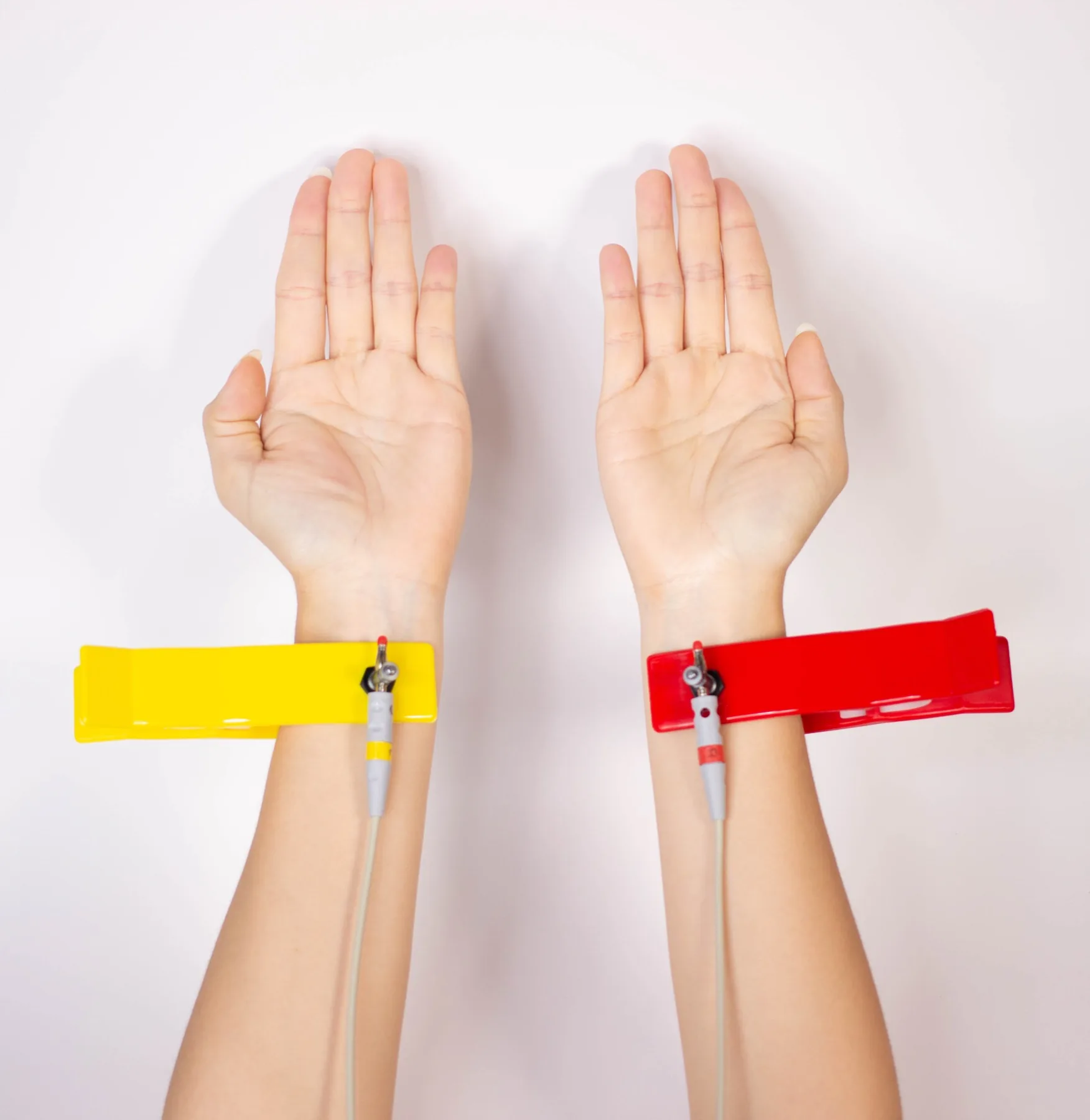 Red and yellow Bio Matrix Scan hand electrodes positioned on both wrists