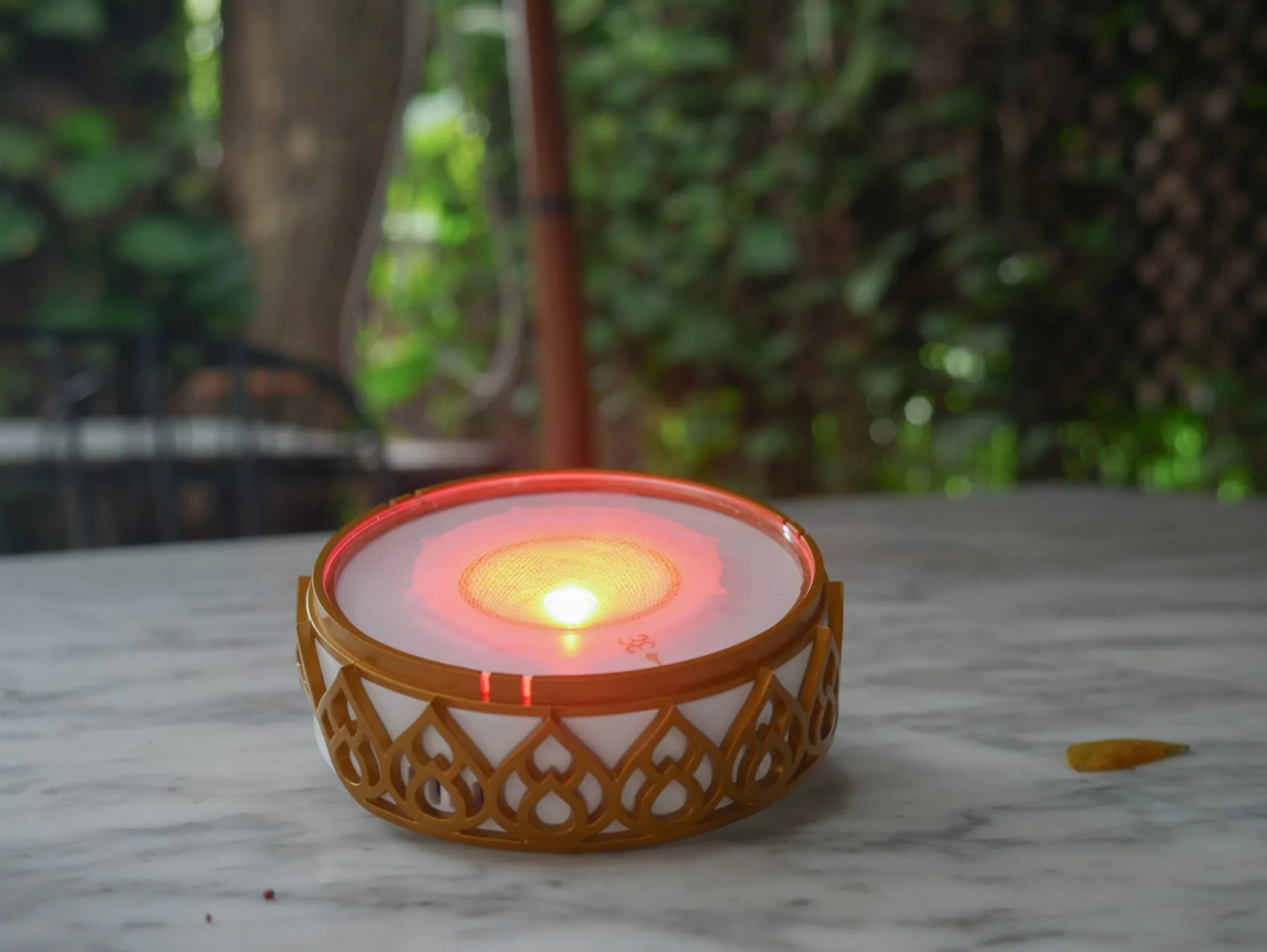 Chakra Activator presenting a warm red color-light program on a stone surface