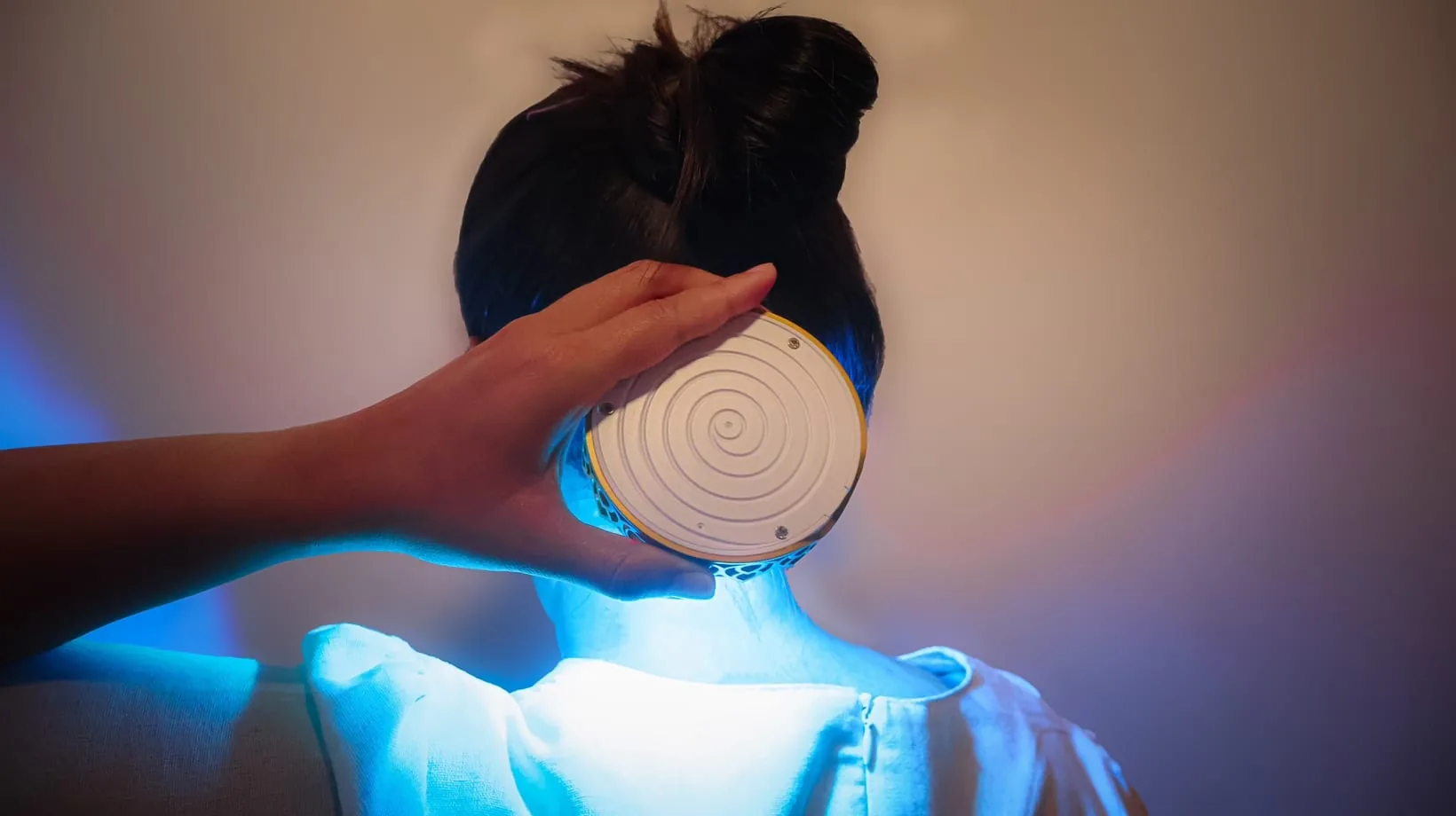 Chakra Activator used near the upper back during a blue-light chakra session