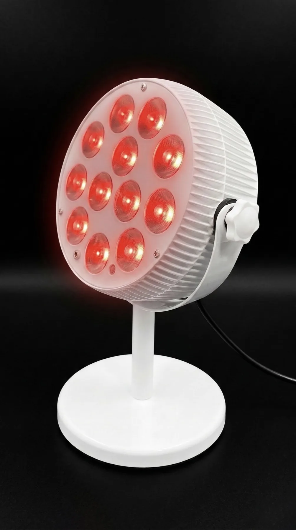 Light Alchemy AuraSync device illuminated in red against a dark studio background