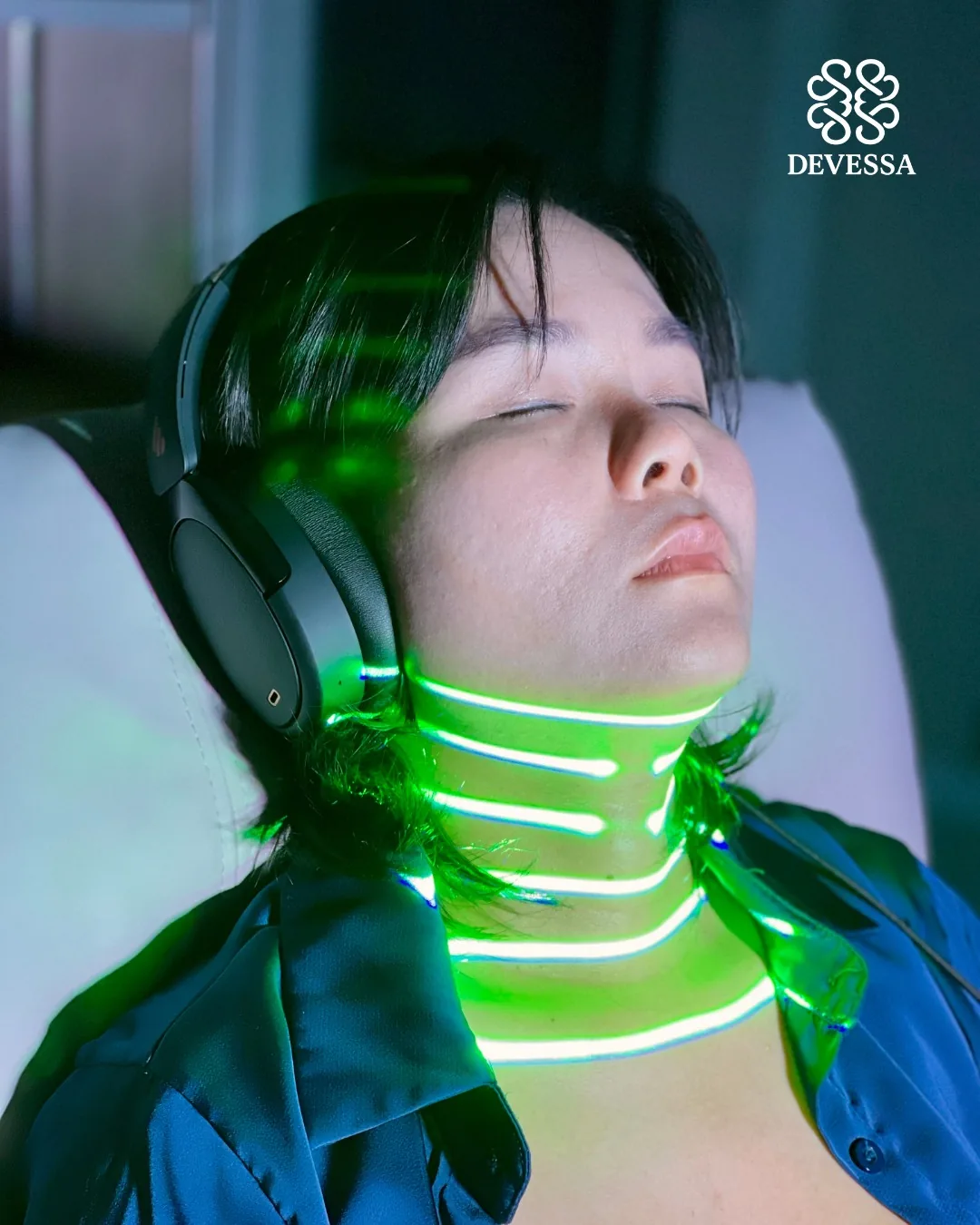 Light Mandalas light tattoo chakra session with a visible wellness participant wearing headphones