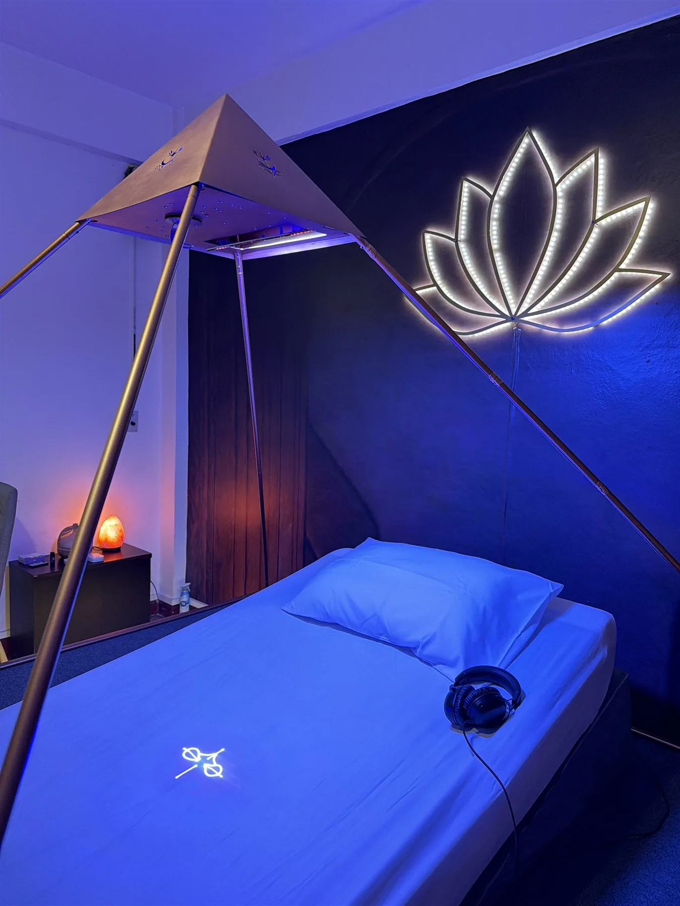 Copper Luminara Pyramid structure with headphones and blue ambient light