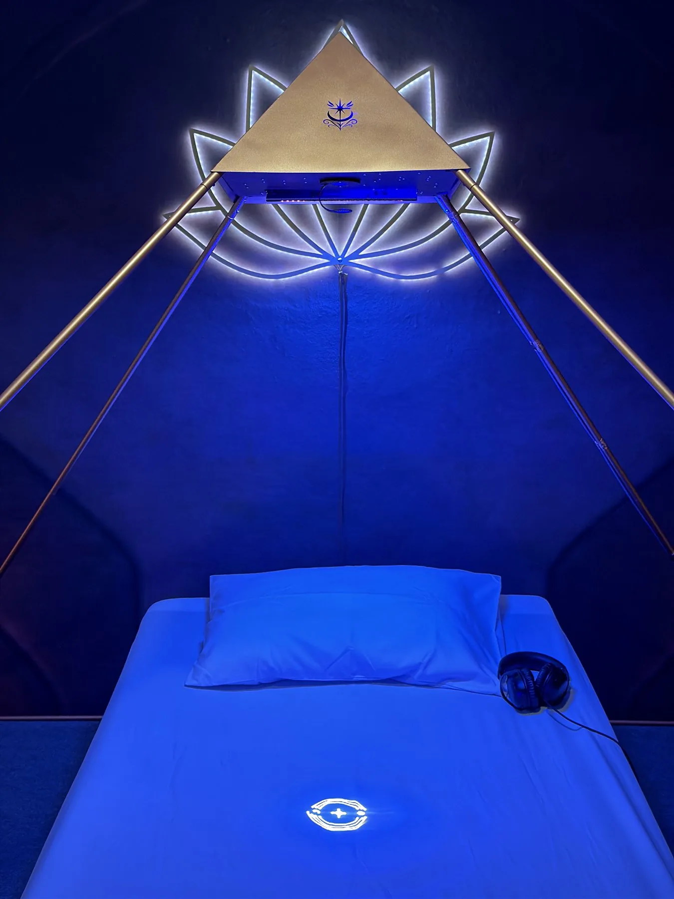 Geometric light symbol projected beneath the Luminara Pyramid
