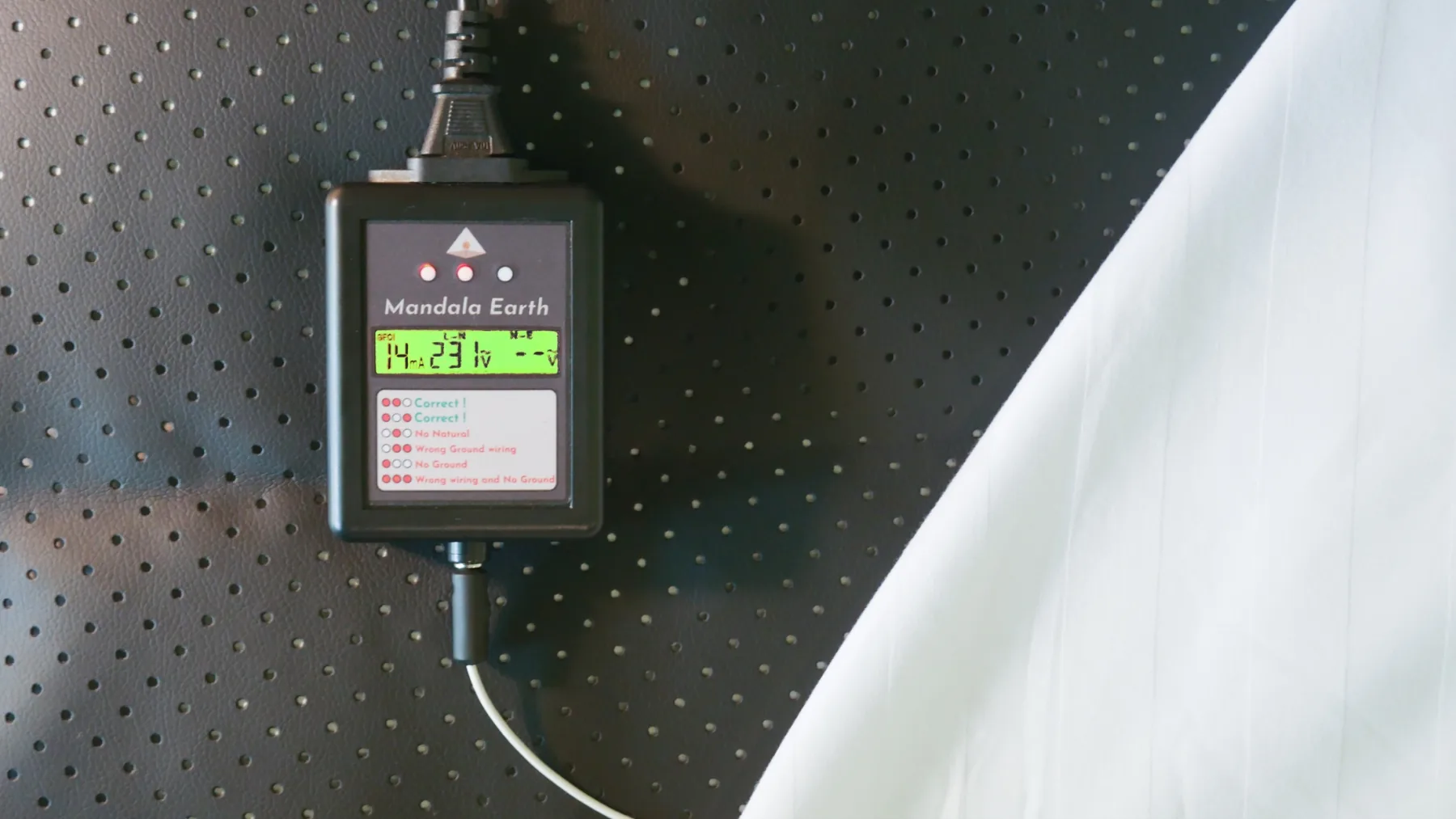 Close view of the Mandala Earth module display and status indicators on the conductive mat