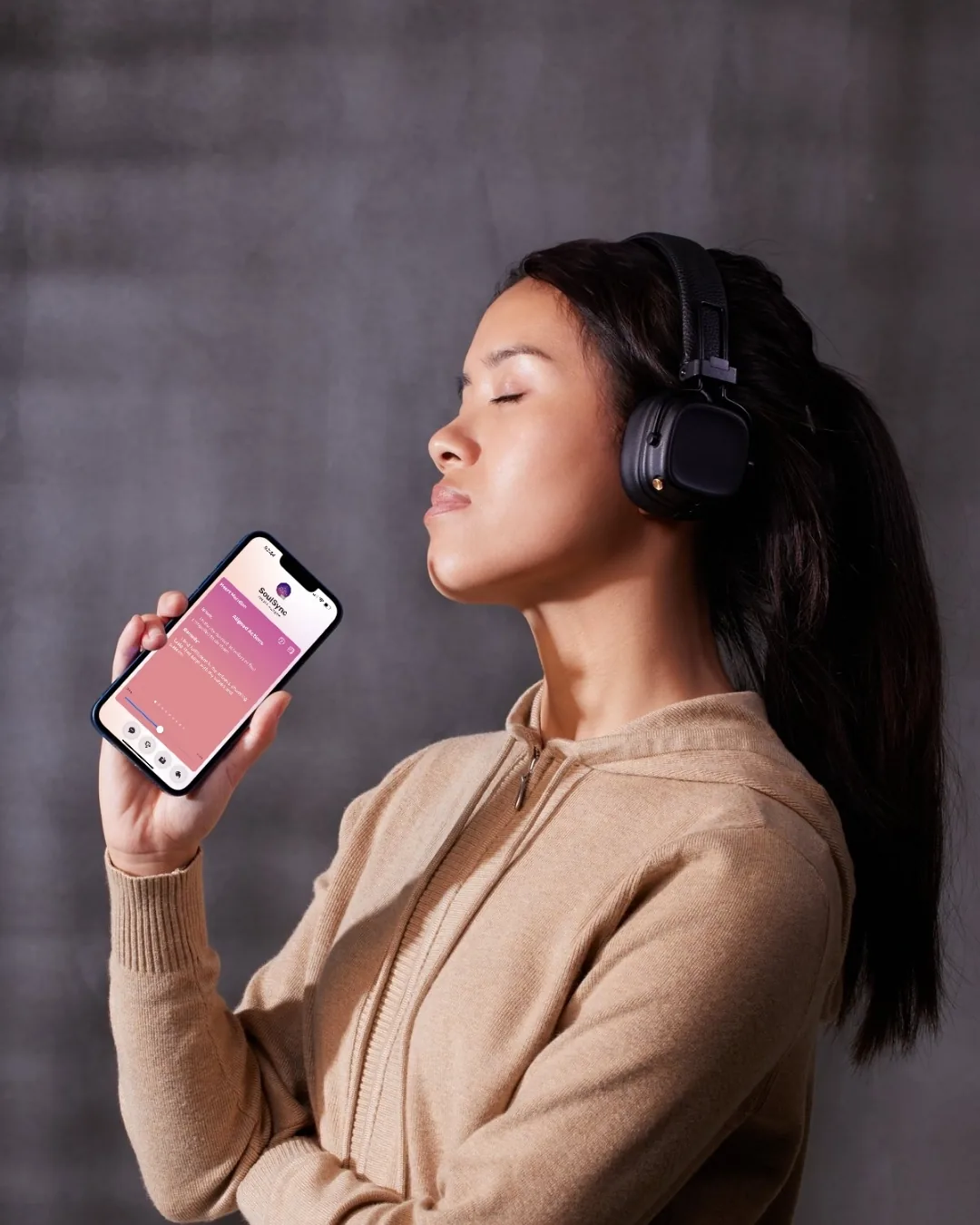 Woman wearing headphones with her full head visible while listening to a SoulSync affirmation session