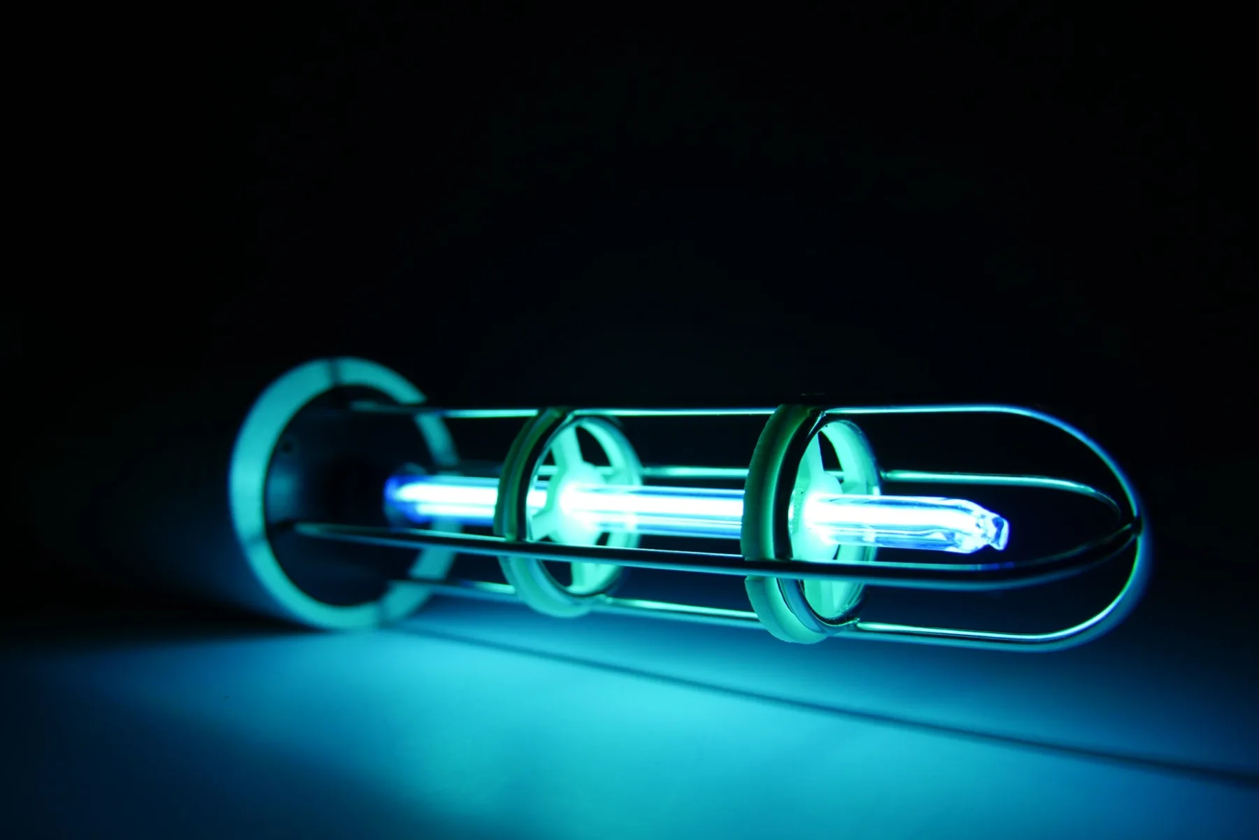 Close view of the Violet Shield plasma tube glowing blue and violet in darkness